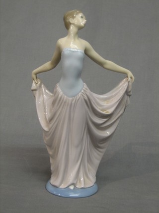 A Lladro figure in the form of a standing lady with ball gown, base marked B24 JU 12"