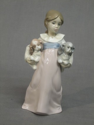 A Lladro figure of a standing girl with 2 puppy dogs, base marked 6419, 8"