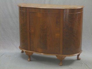 A Georgian style walnut cabinet of serpentine outline, raised on cabriole supports 43"