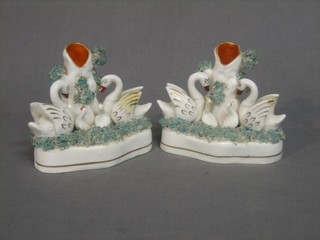 A pair of 19th Century Staffordshire vases decorated swans 5" (f and r)
