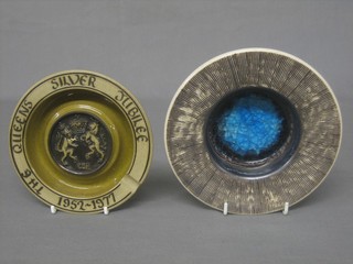 A circular Poole ashtray to commemorate the Queen's Silver Jubilee, base impressed PAW 6" and a circular Purbeck Pottery dish 7"