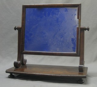 A rectangular plate dressing table mirror contained in a mahogany swing frame, raised on bun feet 18"