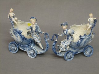 A pair of Continental porcelain vases in the form of chariots supported by cherubs 8" (1f)