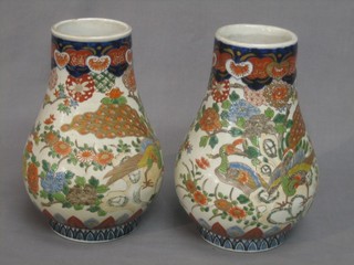 A pair of 19th Century Imari style porcelain flowers of club form decorated birds amidst branches 10"