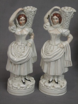 A pair of 19th Century Staffordshire figures of standing ladies with baskets of fruit 11" (1f)