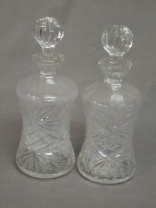 A pair of waisted cut glass decanters and stoppers 12"
