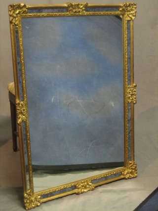 A rectangular plate mirror contained in a decorative frame 37"