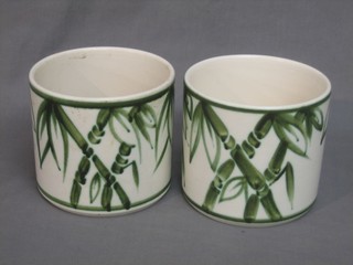 A pair of Poole pottery cylindrical jardinieres with leaf decoration, the base with dolphin mark 6"