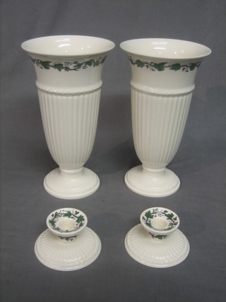 A pair of Wedgwood Stratford pattern trumpet shaped vases 11" and a pair of stub shaped candlesticks 3"