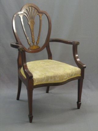 An Edwardian Sheraton style inlaid mahogany shield back carver chair, raised on square tapering supports