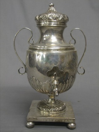 A 19th Century Continental engraved white metal tea urn with embossed body having demi-reeded decoration, raised on a square base with 4 bun feet