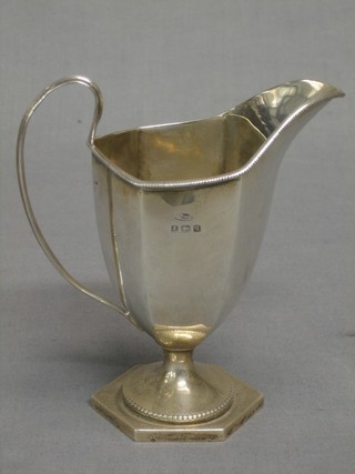 A Georgian style silver cream jug raised on a lozenge shaped foot Birmingham 1915 4 ozs