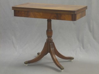 A rectangular Georgian style mahogany card table, raised on pillar and tripod supports 33"