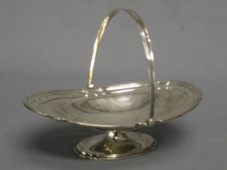 A silver oval cake basket with swing handle, Sheffield 1925 by Mappin & Webb, 15 ozs