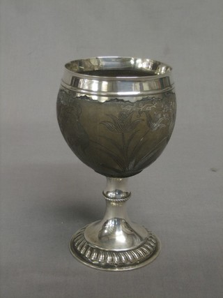 An 18th Century carved coconut and "silver" mounted goblet, carved a crown and leaves 17"