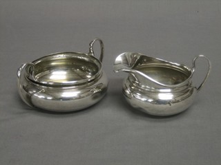 A circular silver cream jug and matching sugar bowl (marks rubbed and dents) 8 ozs