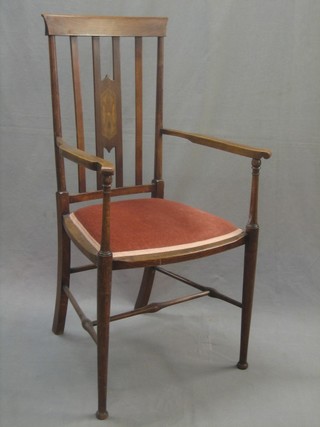 An Edwardian Art Nouveau inlaid mahogany stick and rail back open arm chair