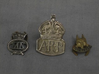 A silver ARP badge, a Merchant Navy lapel badge and a Boy Scout lapel badge