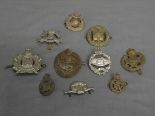 A 9th Lancer's cap badge, a  21st County of London Regiment cap badge, a Kings Own Scottish Borderers cap badge, 2 Tank Corps cap badges, a Royal Marine Light Infantry collar dog, an Army Dental Corps collar dog, a scull and cross bones badge (half missing), an On War Service 1915 badge and a Frontiersman badge