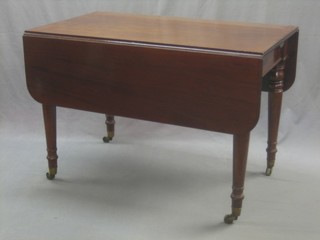 A 19th Century mahogany extending dining table raised on turned supports ending in brass caps and castors 42"