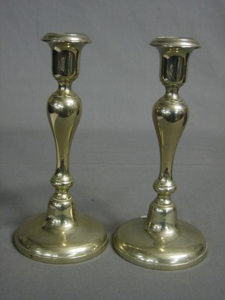 A pair of silver plated candlesticks 9"