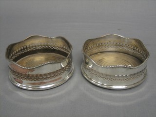 A pair of circular pierced silver plated coasters