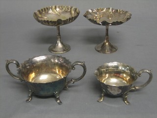 A pair of circular silver plated comports 5" and a silver plated twin handled sugar bowl and cream jug