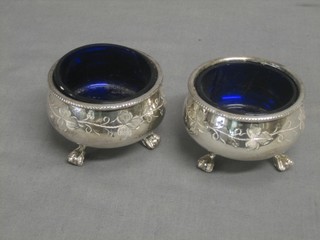 A pair of Victorian engraved silver plated salts with blue glass liners