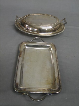 An oval silver plated entree dish and cover and a rectangular silver plated twin handled tray