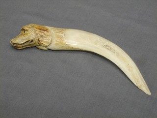 An ivory paper knife in the form of a dogs head 6"