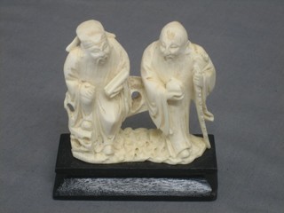 A carved ivory figure group in the form of 2 standing sages 3 1/2"