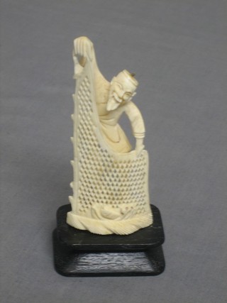 A carved ivory figure group of a fisherman 4"