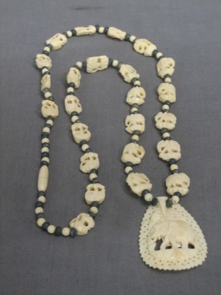 A carved ivory pendant decorated an elephant hung on a string of ivory beads