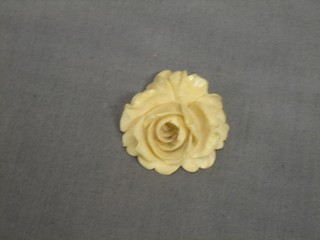 A carved ivory pendant in the form of a flower head 1"