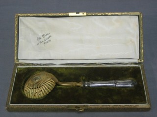 A French silver sifter spoon with gilt metal bowl and silver handle, cased