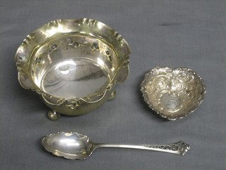 An embossed silver dish 2 1/2", a circular embossed silver plated sugar bowl 4" and a silver plated spoon