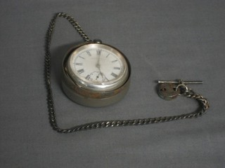 An open faced pocket watch by Waltham contained in a silver case hung on a curb link chain