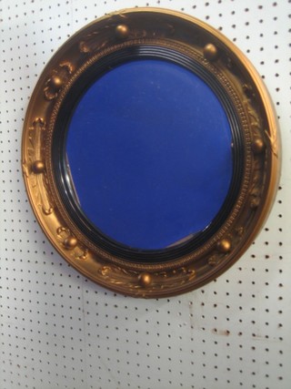 A circular plate wall mirror contained in a gilt ball studded frame  16"