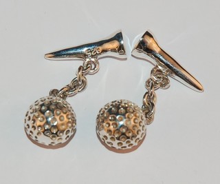 A pair of modern silver cufflinks in the form of golf balls and tees