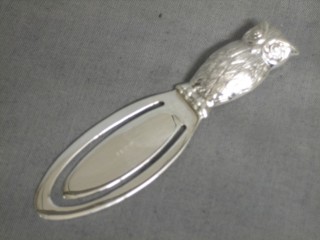 A modern silver bookmark in the form of an owl