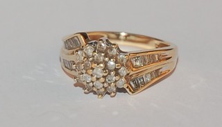 A gold cluster dress ring set diamonds and with diamonds to the shoulders