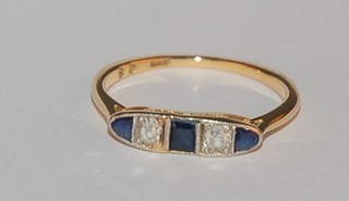 An 18ct yellow gold dress ring set 4 sapphires supported by diamonds