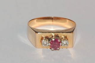 A gold dress ring set a ruby and 2 diamonds