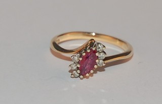 A 9ct gold dress ring set an oval cut ruby and diamonds