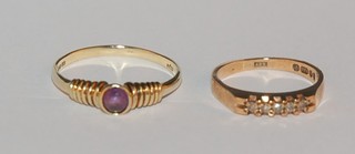 A 9ct gold dress ring set an oval red cut stone and 1 other set white stones