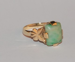A gold dress ring set a rectangular green hardstone
