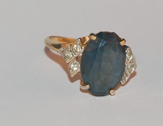A gilt metal ring set a blue stone