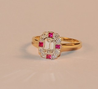 A  lady's 18ct yellow gold dress ring set a lozenge cut diamond to the centre supported by 4 square cut rubies and numerous diamonds