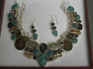 A silver necklet with matching earrings, set various hardstones, amonites, turquoise, smokey quartz, mother of pearl etc