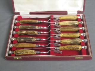 A set of 6 silver plated steak knives with stag horn handles by Garrards, cased